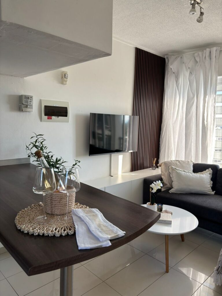 Bright living area with sofa and dining table