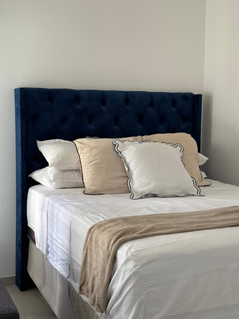 Queen bed with navy headboard
